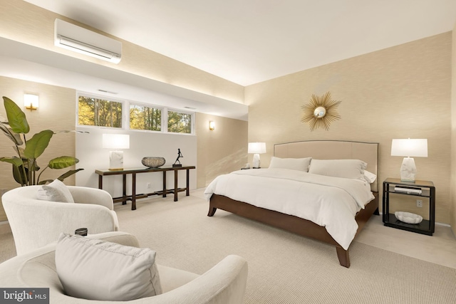 bedroom with a wall mounted air conditioner and light colored carpet