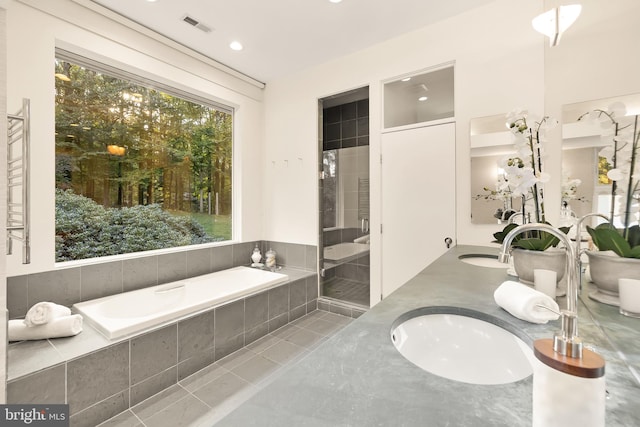 bathroom with vanity, shower with separate bathtub, and tile patterned floors