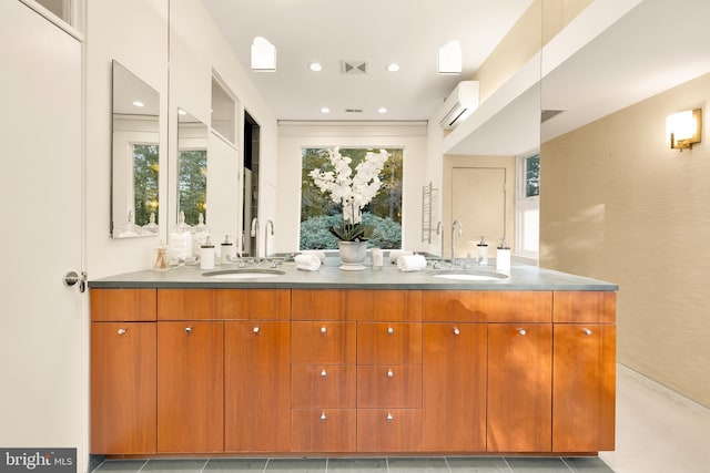 bathroom featuring vanity, an AC wall unit, and tile patterned floors