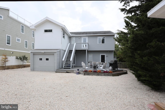 back of property with a garage