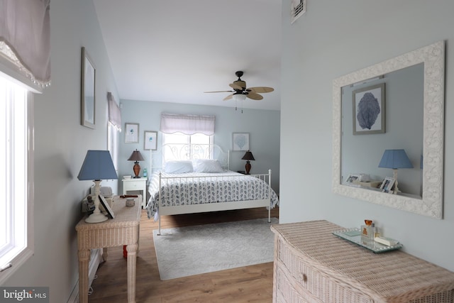 bedroom with wood-type flooring and ceiling fan