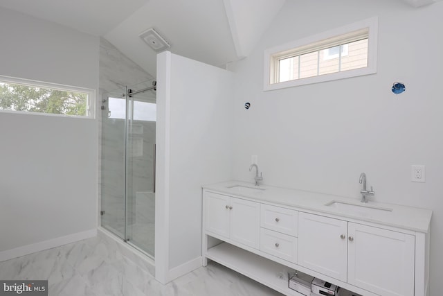 bathroom with vanity, lofted ceiling, and a shower with shower door