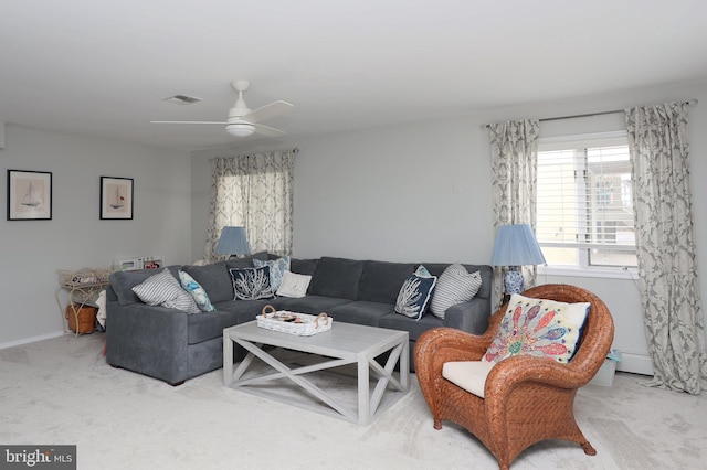 living room with ceiling fan, baseboard heating, and carpet