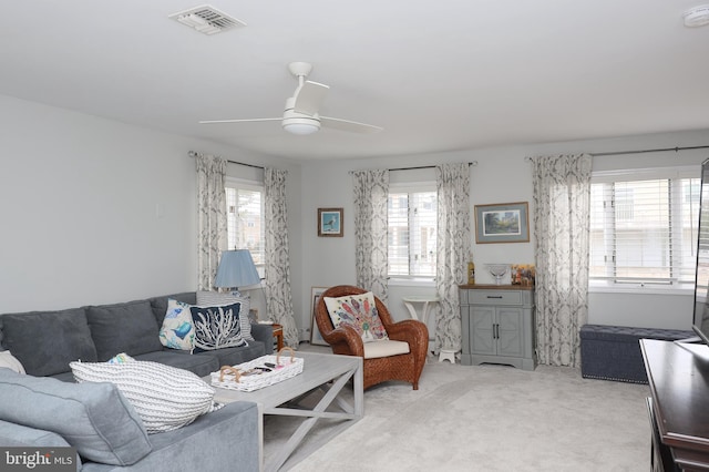 living room with carpet, ceiling fan, and a wealth of natural light