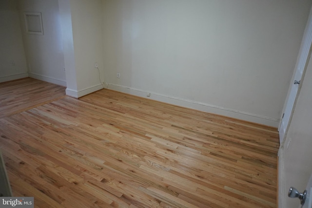 unfurnished room with light wood-type flooring