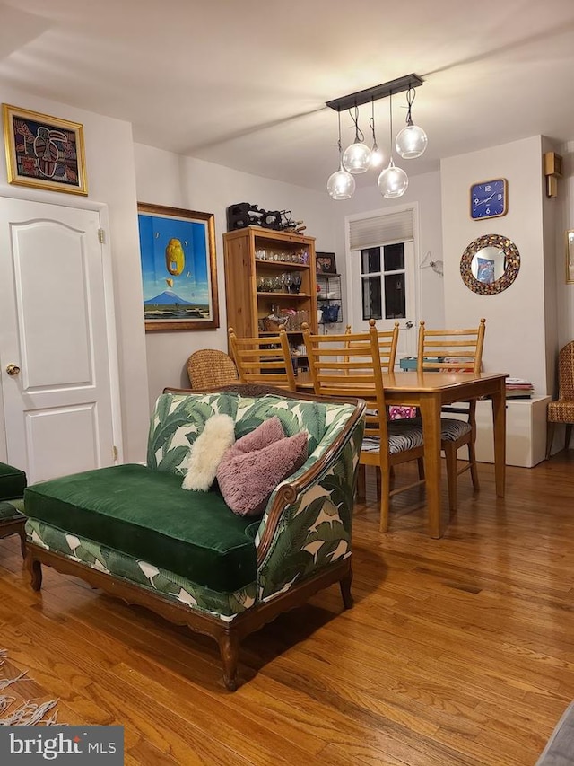 living room with hardwood / wood-style flooring and an inviting chandelier