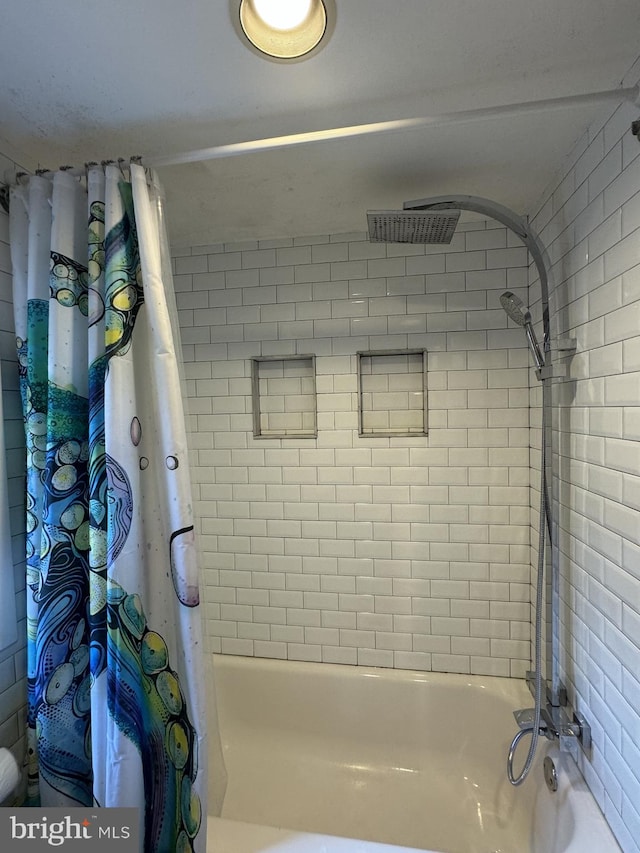 bathroom with shower / bath combo with shower curtain