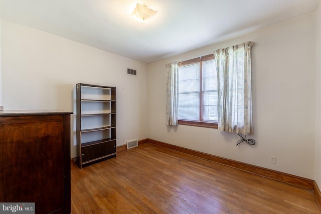 unfurnished bedroom with hardwood / wood-style flooring