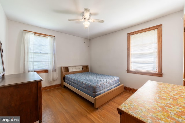 bedroom with light hardwood / wood-style floors and ceiling fan