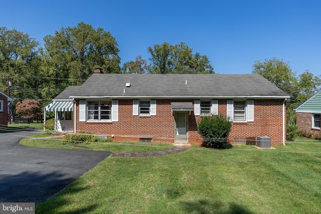 back of property with a lawn and central AC