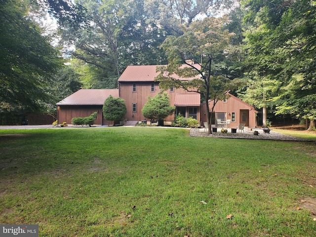 view of front of property with a front yard and metal roof