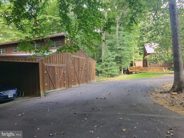 exterior space with an outbuilding and a wooded view