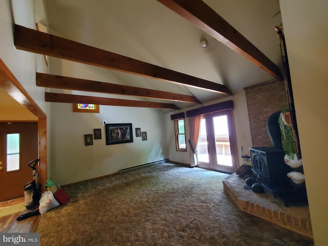 unfurnished living room featuring a wood stove, vaulted ceiling with beams, and carpet