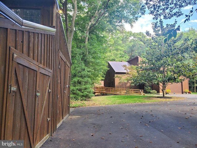 view of home's exterior with a garage and an outbuilding