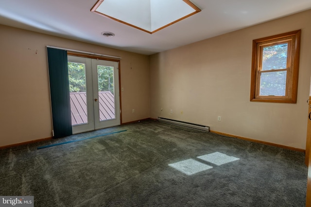 carpeted spare room with a baseboard heating unit, a healthy amount of sunlight, and a skylight