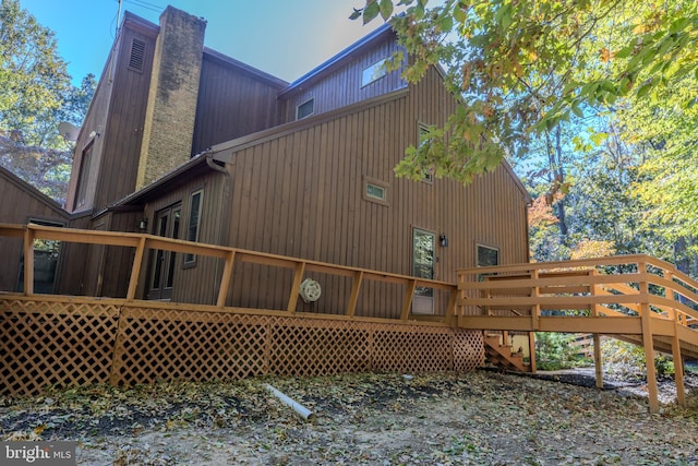 view of side of home with a wooden deck