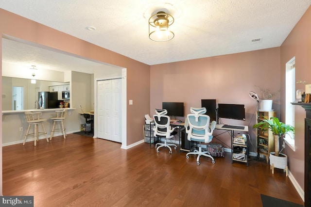 office space with wood-type flooring and a textured ceiling