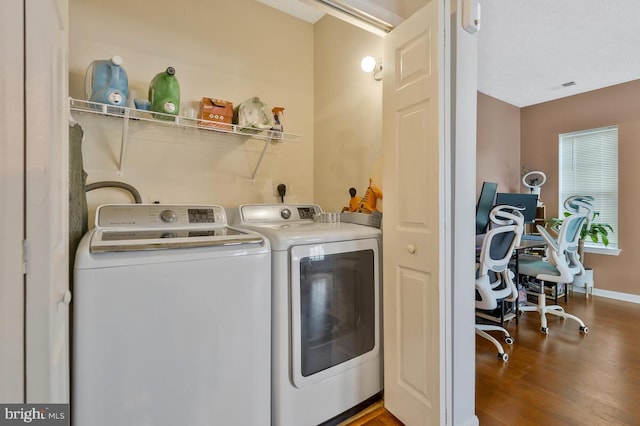 laundry area featuring washer and dryer and hardwood / wood-style floors