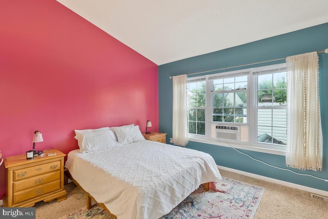 carpeted bedroom with cooling unit and vaulted ceiling