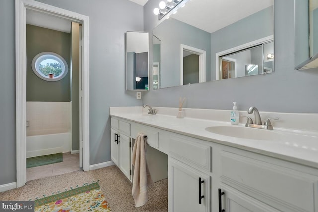 bathroom with vanity, tile patterned flooring, and a tub