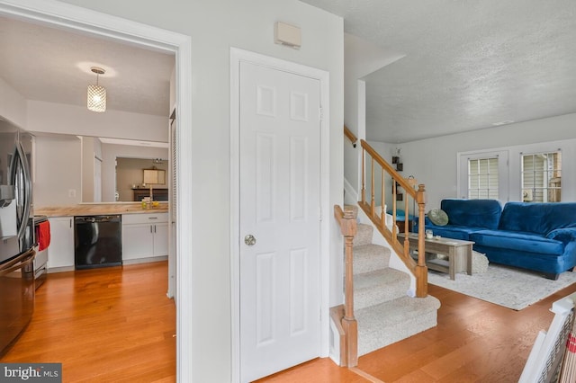 interior space with a textured ceiling and hardwood / wood-style flooring