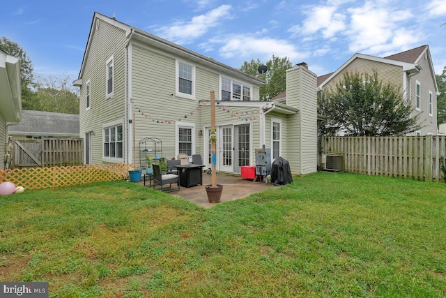 back of property with a lawn, a patio, and central AC unit