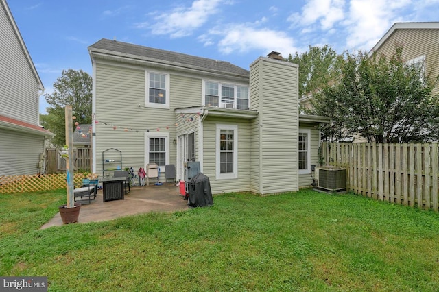 back of house with a patio, central AC, and a yard