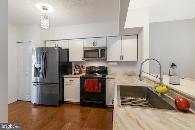 kitchen featuring white cabinetry, dark hardwood / wood-style flooring, pendant lighting, and stainless steel appliances