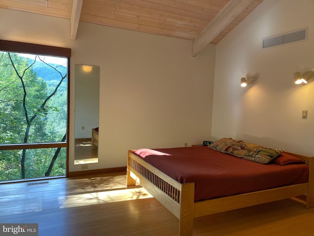 bedroom with wood ceiling, light hardwood / wood-style floors, and lofted ceiling with beams