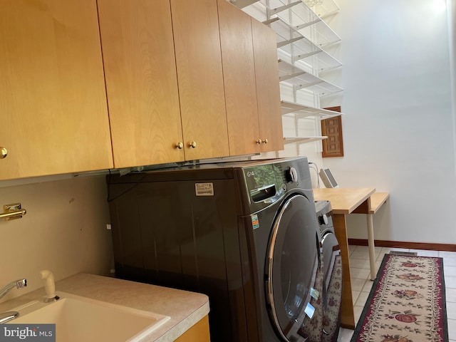 washroom with cabinets, tile patterned floors, sink, and washer / dryer