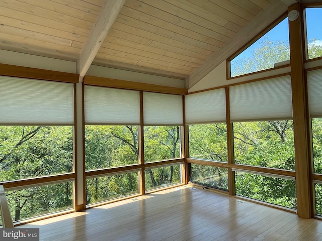 unfurnished sunroom with lofted ceiling with beams and wood ceiling