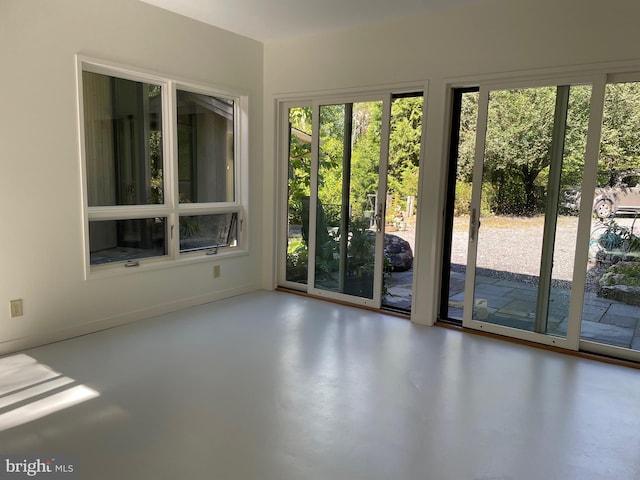 interior space featuring concrete flooring and a healthy amount of sunlight