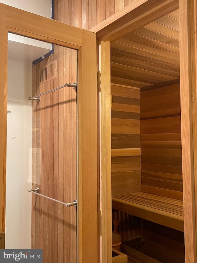 view of sauna featuring wooden walls