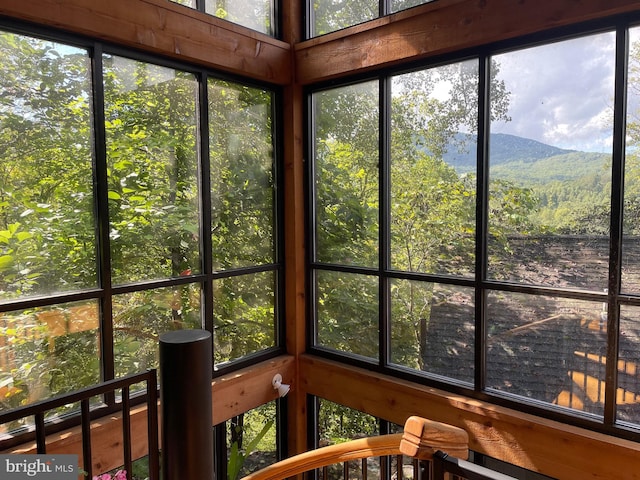 unfurnished sunroom with a mountain view