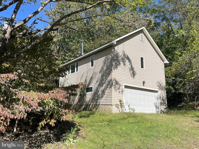 view of home's exterior featuring a lawn and a garage