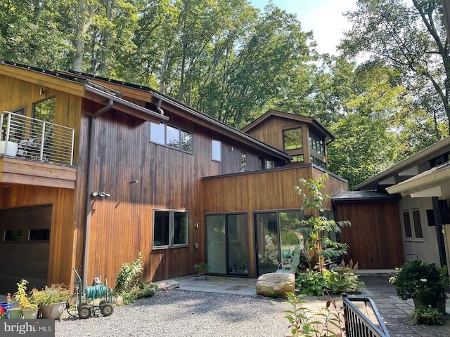 view of front of property with a garage and a patio area