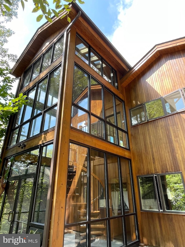 view of side of home featuring a sunroom