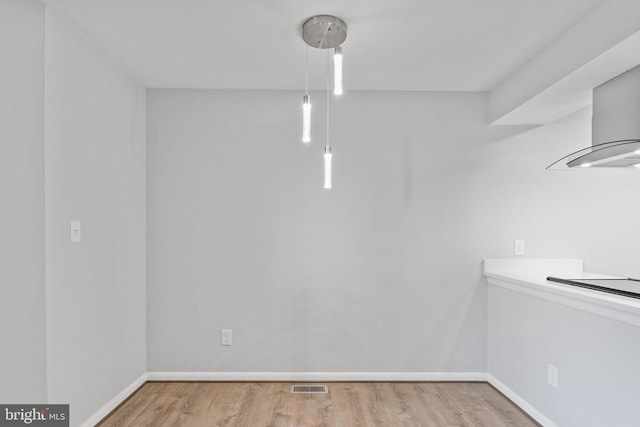 unfurnished dining area with light hardwood / wood-style floors