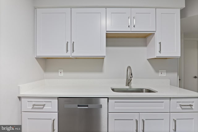 kitchen with white cabinets, sink, and stainless steel dishwasher