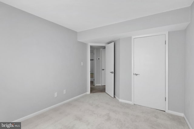 unfurnished bedroom featuring light colored carpet