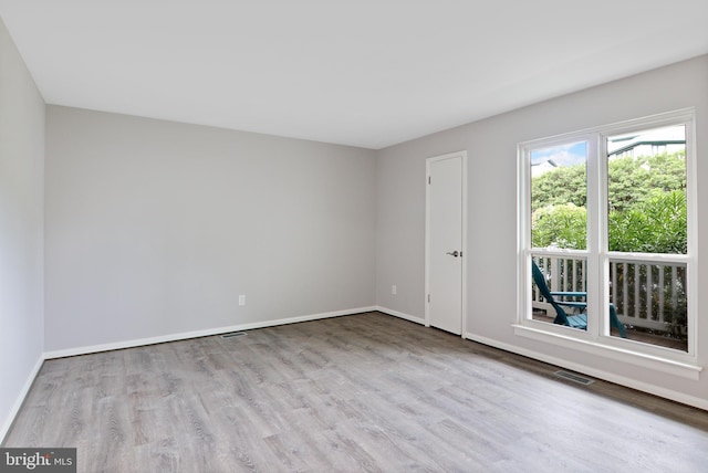 spare room featuring light hardwood / wood-style floors