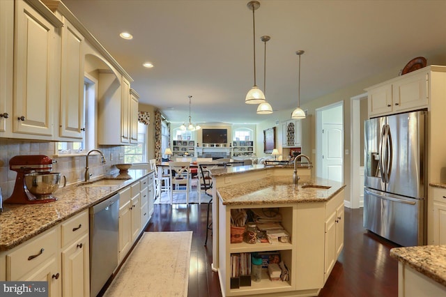 kitchen featuring backsplash, dark wood-type flooring, stainless steel appliances, and a sink