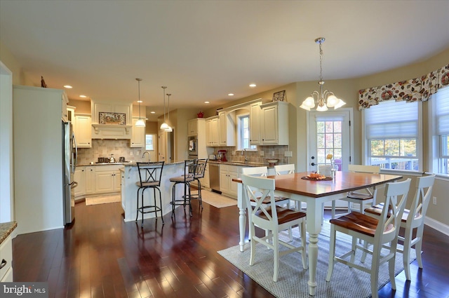 dining room featuring a chandelier, dark wood-style flooring, baseboards, and recessed lighting