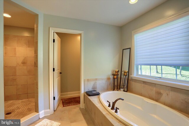 full bathroom featuring recessed lighting, a garden tub, a tile shower, and baseboards