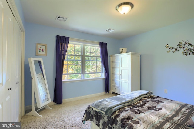 bedroom featuring a closet, visible vents, and baseboards