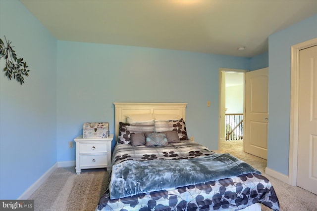 bedroom with carpet floors and baseboards