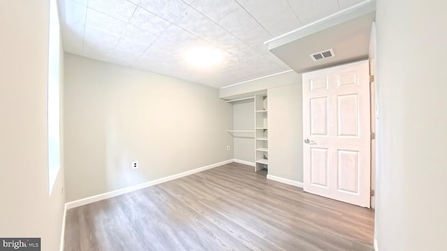 unfurnished bedroom featuring a closet and wood-type flooring