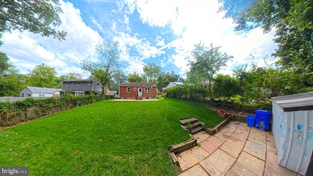 view of yard with a patio area and an outbuilding