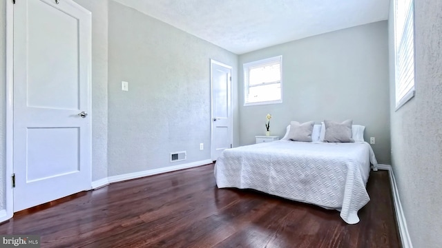 bedroom featuring dark hardwood / wood-style floors