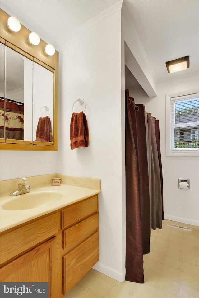 full bathroom with crown molding, tile patterned floors, vanity, and baseboards